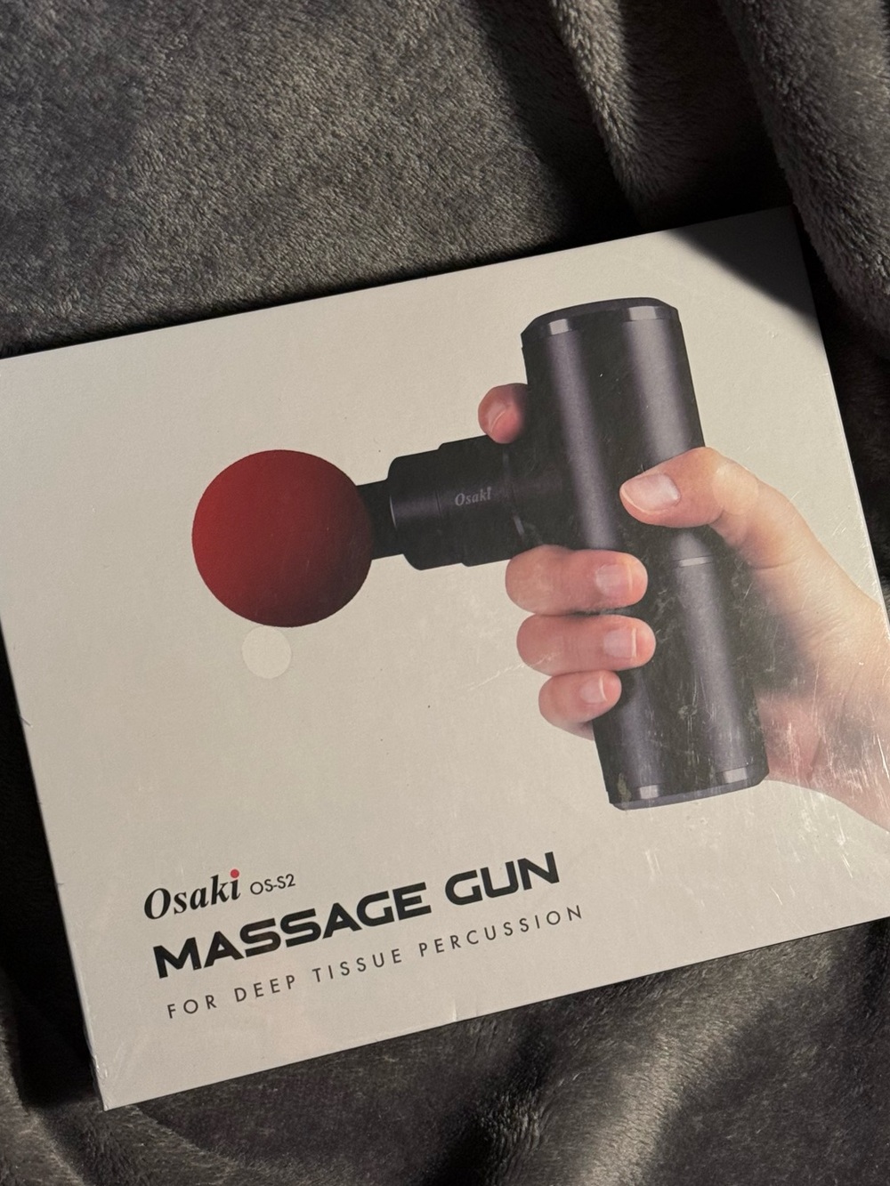 Osaki black massage gun with silver accent and ball head